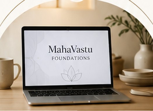 Laptop showing a MahaVastu Foundations course on a warm desk