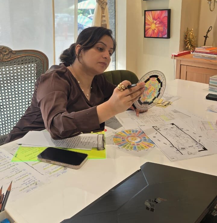 MahaVastu consultant studying a zone chart over floor plans